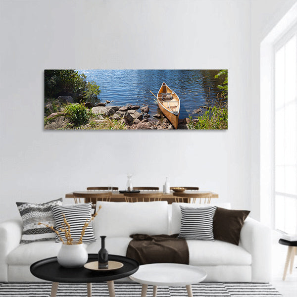 A yellow fisherman's canoe on a rocky shore panoramic canvas wall art