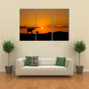 Elephants in African savannah at sunset multi panel canvas wall art