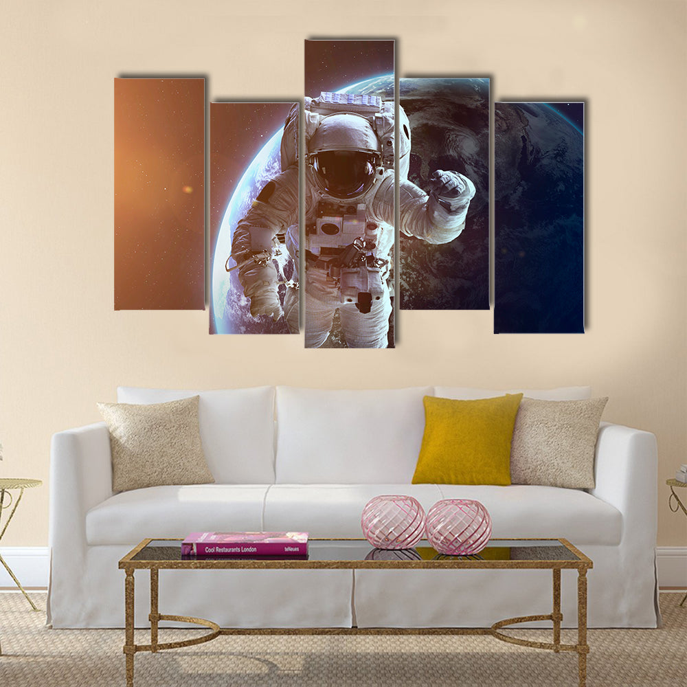 NASA's astronaut in open space Multi Panel Canvas Wall Art