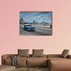 Classic american car drive on Malecon sea front promenade canvas wall art