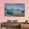 Classic american car drive on Malecon sea front promenade canvas wall art