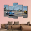 Classic american car drive on Malecon sea front promenade canvas wall art