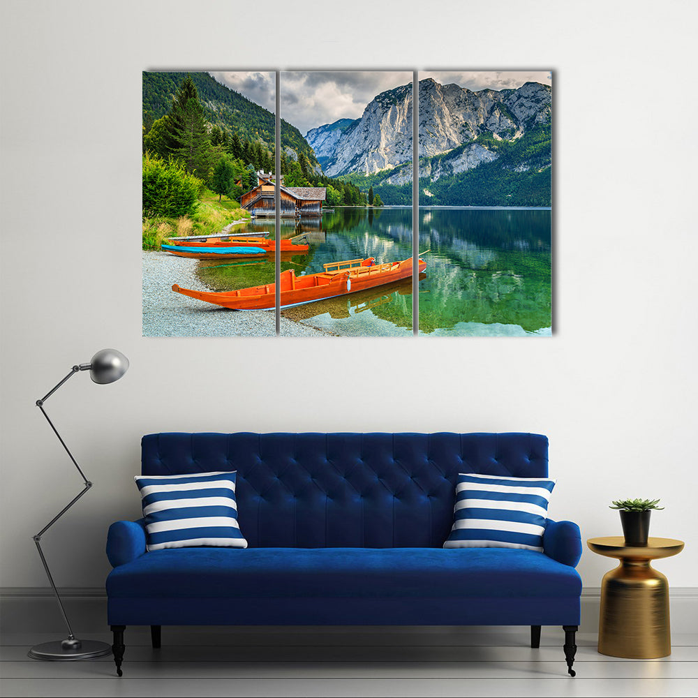 Wooden boat dock with traditional boats and high rocky mountains multi panel canvas wall art
