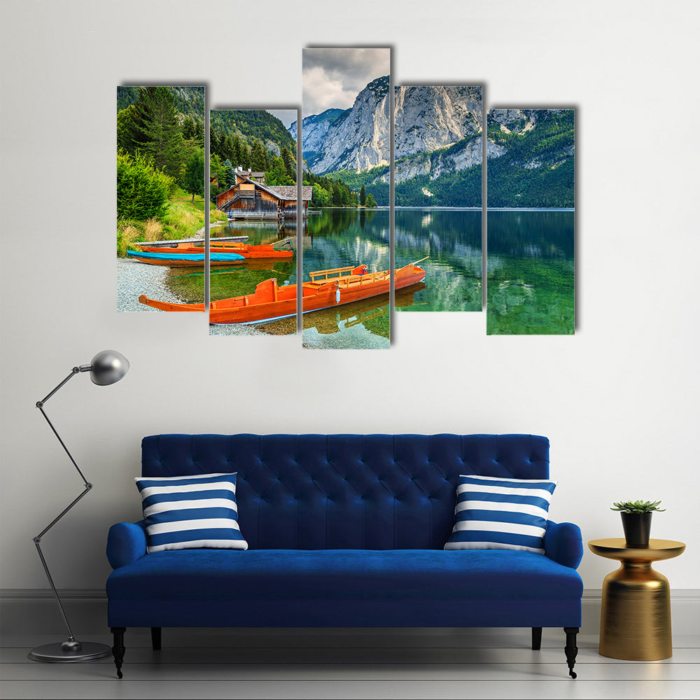 Wooden boat dock with traditional boats and high rocky mountains multi panel canvas wall art