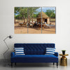 Himba village with traditional huts near Etosha National Park in Namibia Africa Multi panel canvas wall art