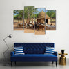 Himba village with traditional huts near Etosha National Park in Namibia Africa Multi panel canvas wall art