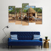 Himba village with traditional huts near Etosha National Park in Namibia Africa Multi panel canvas wall art