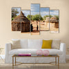 Himba village with traditional huts near Etosha National Park in Namibia, Africa Multi panel canvas wall art