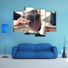 Back view of Man in Barber shop Barber Cutting Hair with Scissors Multi Panel Canvas Wall Art