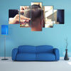 Back view of Man in Barber shop Barber Cutting Hair with Scissors Multi Panel Canvas Wall Art