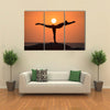 Warrior pose from yoga by woman silhouette on sunset Multi panel canvas wall art