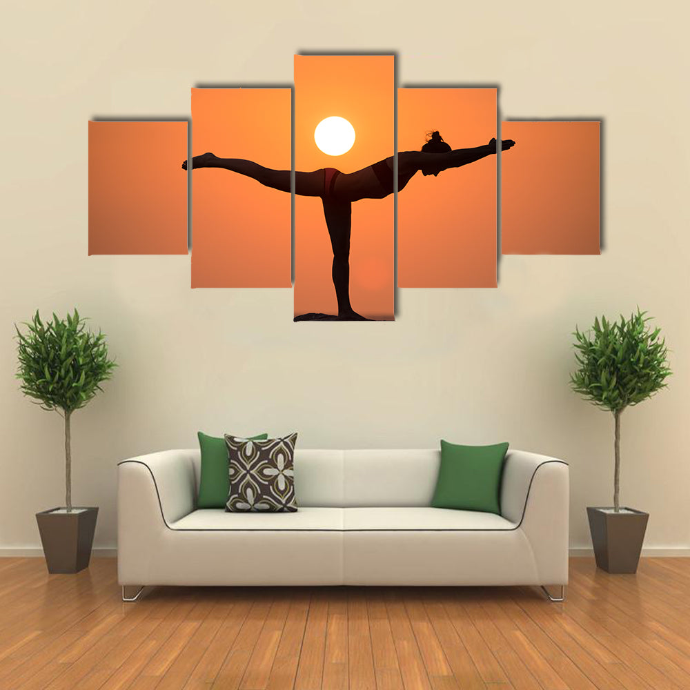 Warrior pose from yoga by woman silhouette on sunset Multi panel canvas wall art