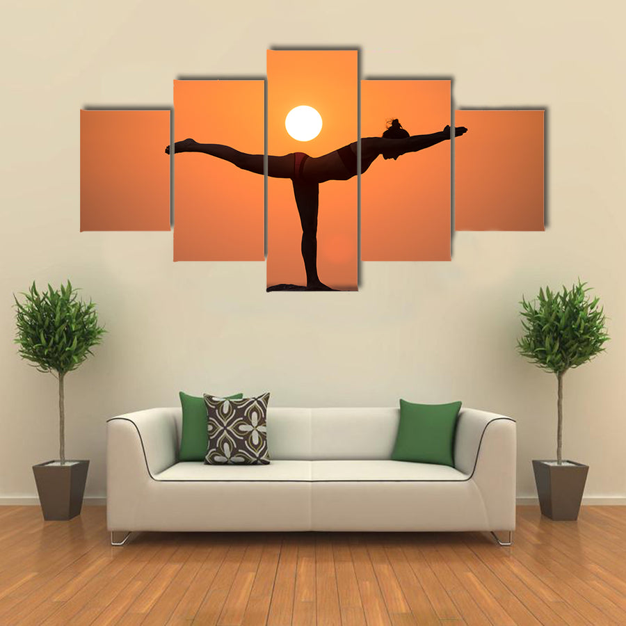 Warrior pose from yoga by woman silhouette on sunset Multi panel canvas wall art