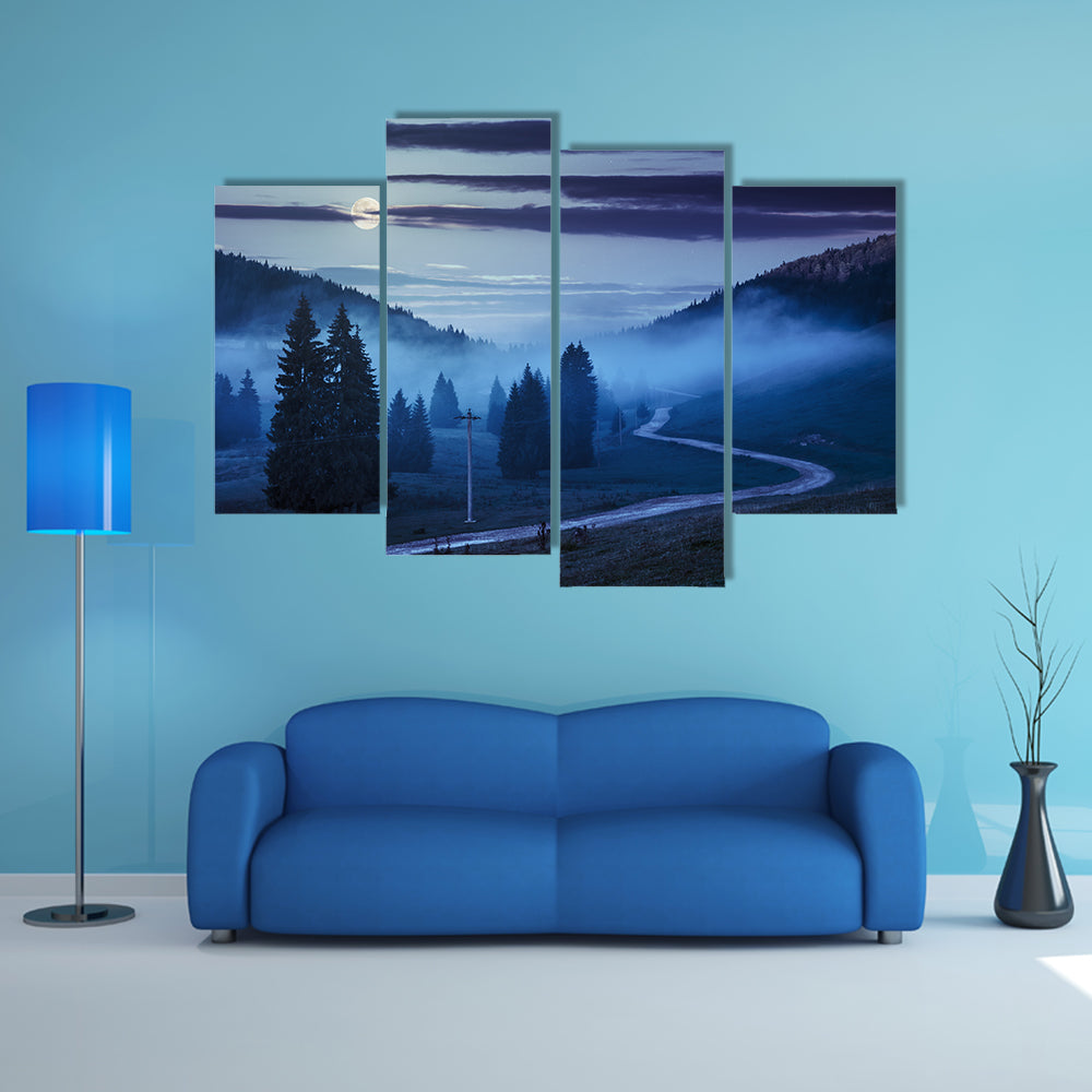 The Road On Through The Meadow Near Few Fir Trees And Forest in foggy mountains Multi Panel Canvas Wall Art