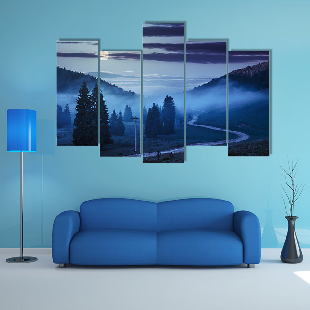 The Road On Through The Meadow Near Few Fir Trees And Forest in foggy mountains Multi Panel Canvas Wall Art