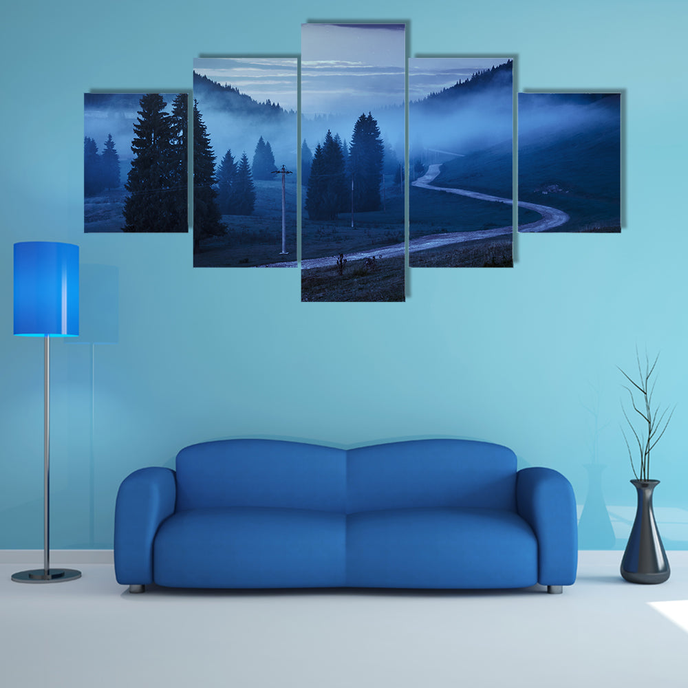 The Road On Through The Meadow Near Few Fir Trees And Forest in foggy mountains Multi Panel Canvas Wall Art