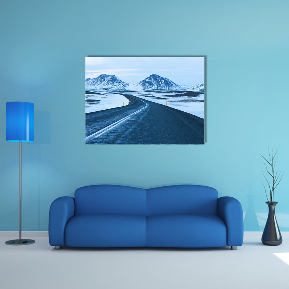 The road at twilight through the snow capped mountains in winter multi panel canvas wall art