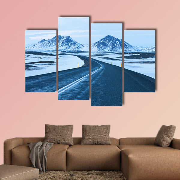 The road at twilight through the snow capped mountains canvas wall art