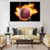 Football ball with the national flag of qatar on fire on a black Multi panel canvas wall art