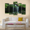 A small water fall flows on a rock ledge Multi Panel Canvas Wall Art