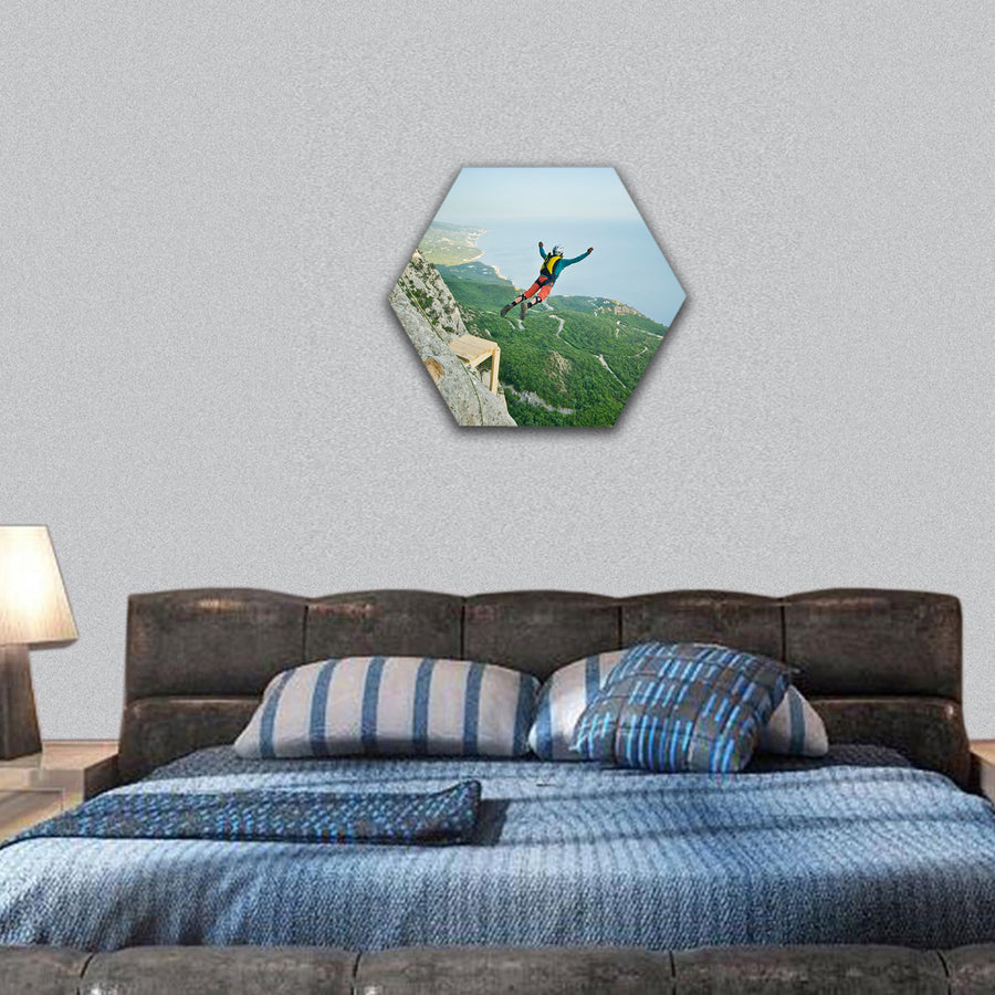 base-jumper prepare to jump from the cliff in mountains hexagonal canvas wall art