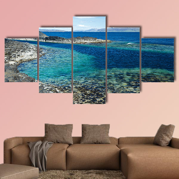 Black rock with the turquoise blue water of the sea at Staffa wall art