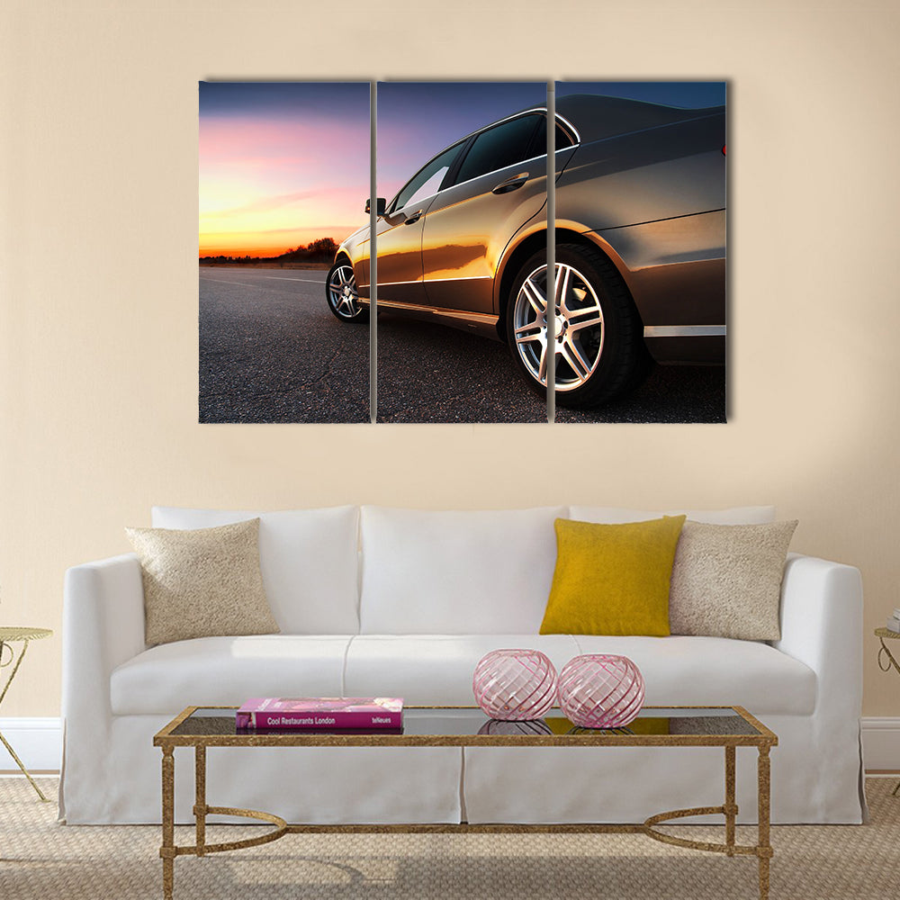 Rear-side view of a luxury car on sunset Multi panel canvas wall art