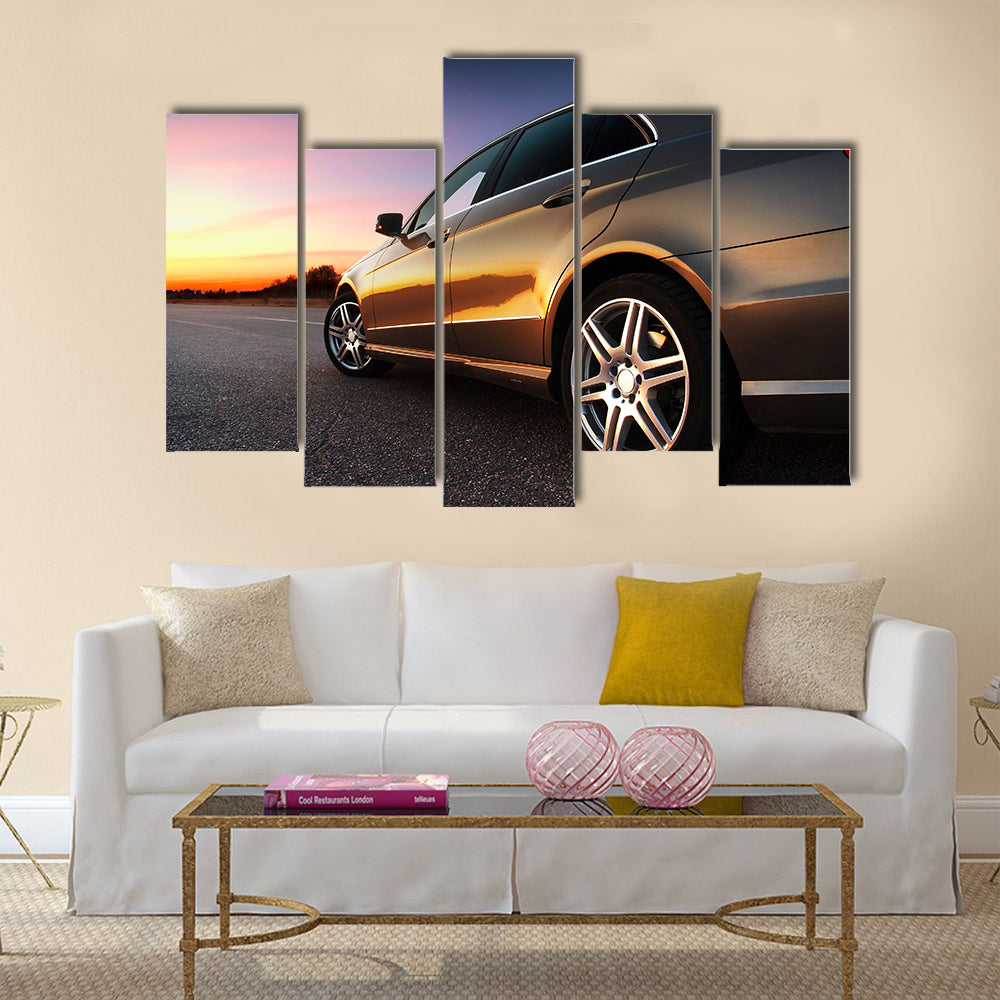 Rear-side view of a luxury car on sunset Multi panel canvas wall art