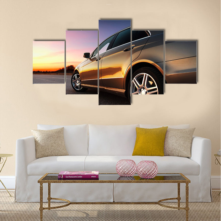 Rear-side view of a luxury car on sunset Multi panel canvas wall art