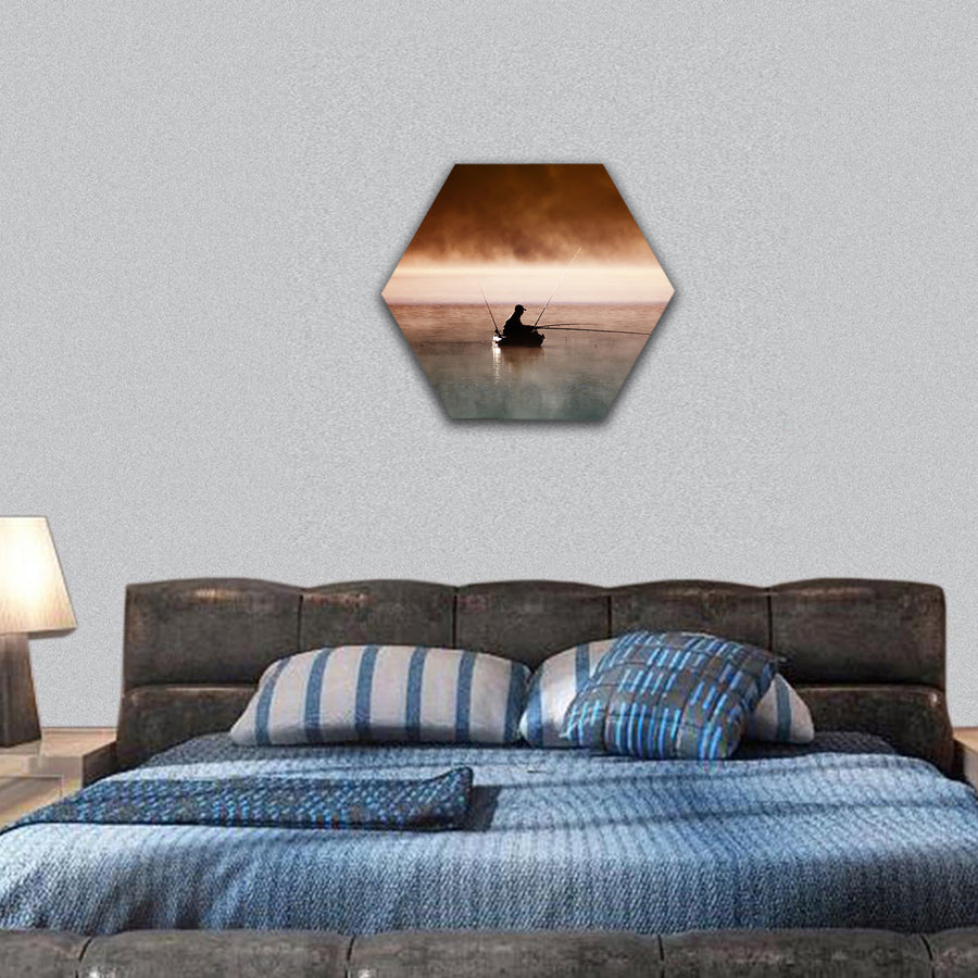 A fisherman sits in boat and catches fish hexagonal canvas wall art
