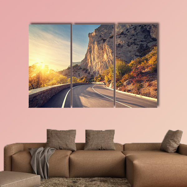 Asphalt road in autumn forest at sunrise multi panel canvas wall art