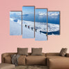 A group of people randonee ski walking high above the fjords. Lyngen Alps, Norway Multi panel canvas wall art