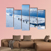 A group of people randonee ski walking high above the fjords. Lyngen Alps, Norway Multi panel canvas wall art