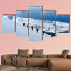 A group of people randonee ski walking high above the fjords. Lyngen Alps, Norway Multi panel canvas wall art