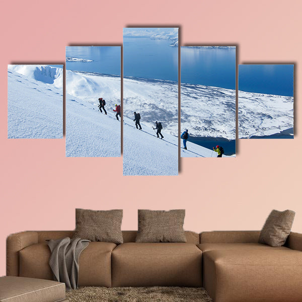 A group of people randonee ski walking high above the fjords. Lyngen Alps, Norway Multi panel canvas wall art