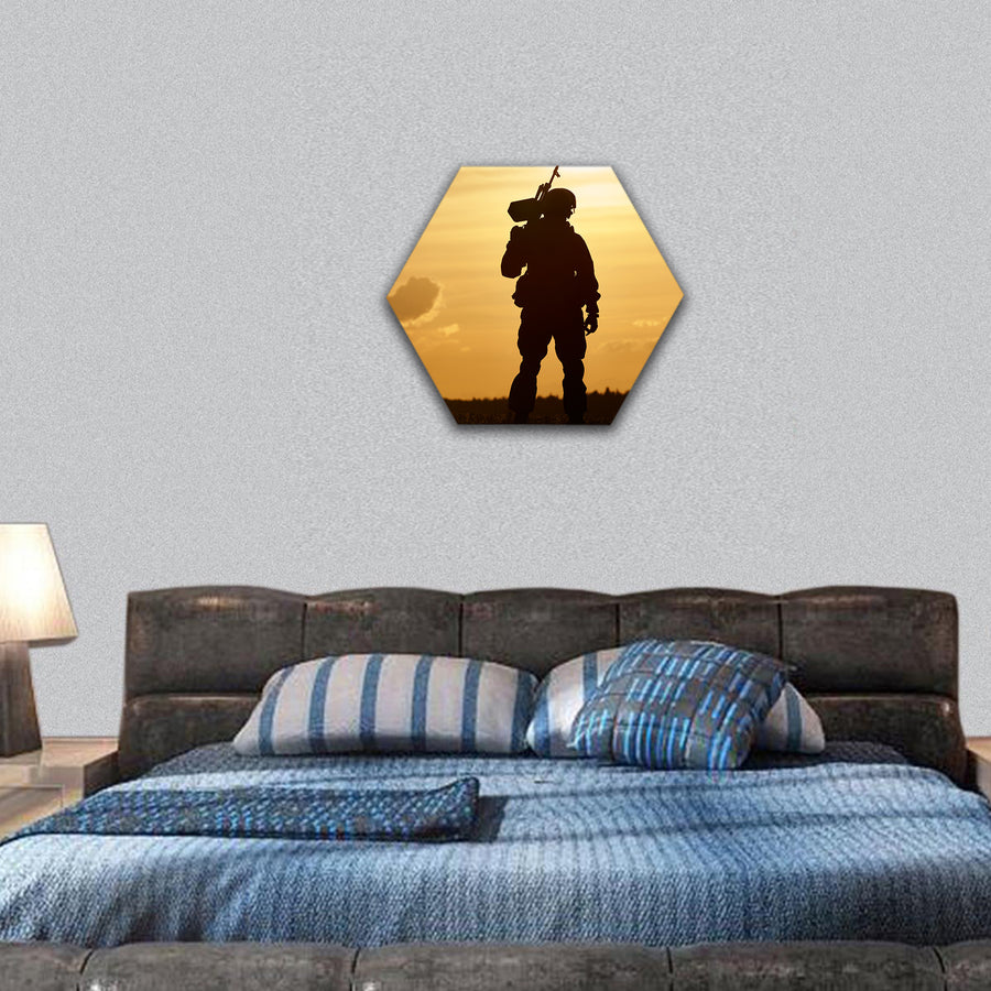 Soldier silhouette in uniform with machine gun hexagonal canvas wall art