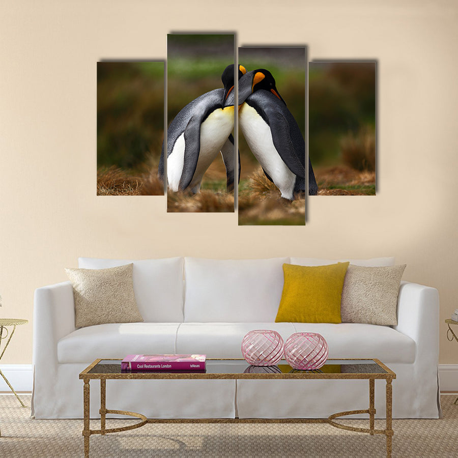 King penguin couple cuddling in wild nature with green background multi Panel Canvas wall Art