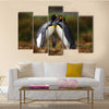 King penguin couple cuddling in wild nature with green background multi Panel Canvas wall Art