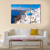 Panoramic scenic view of beautiful white houses and blue domes in Oia, Santorini, Greece Multi Panel Canvas Wall Art