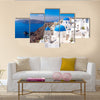 Panoramic scenic view of beautiful white houses and blue domes in Oia, Santorini, Greece Multi Panel Canvas Wall Art