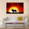 Lonesome lion in a sunset of the sahara desert Multi panel canvas wall art