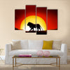 Lonesome lion in a sunset of the sahara desert Multi panel canvas wall art