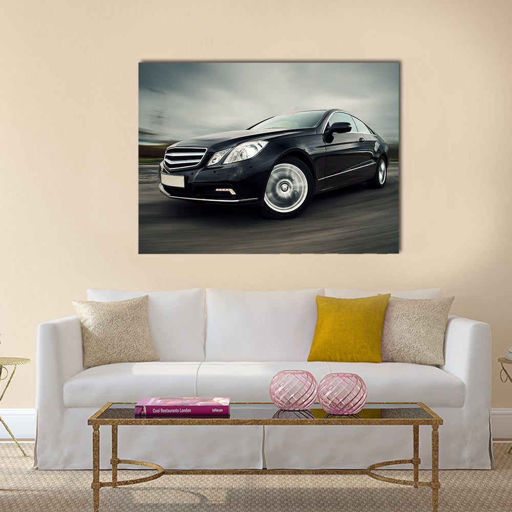 Front view of black luxury coupe driving fast Multi panel canvas wall art