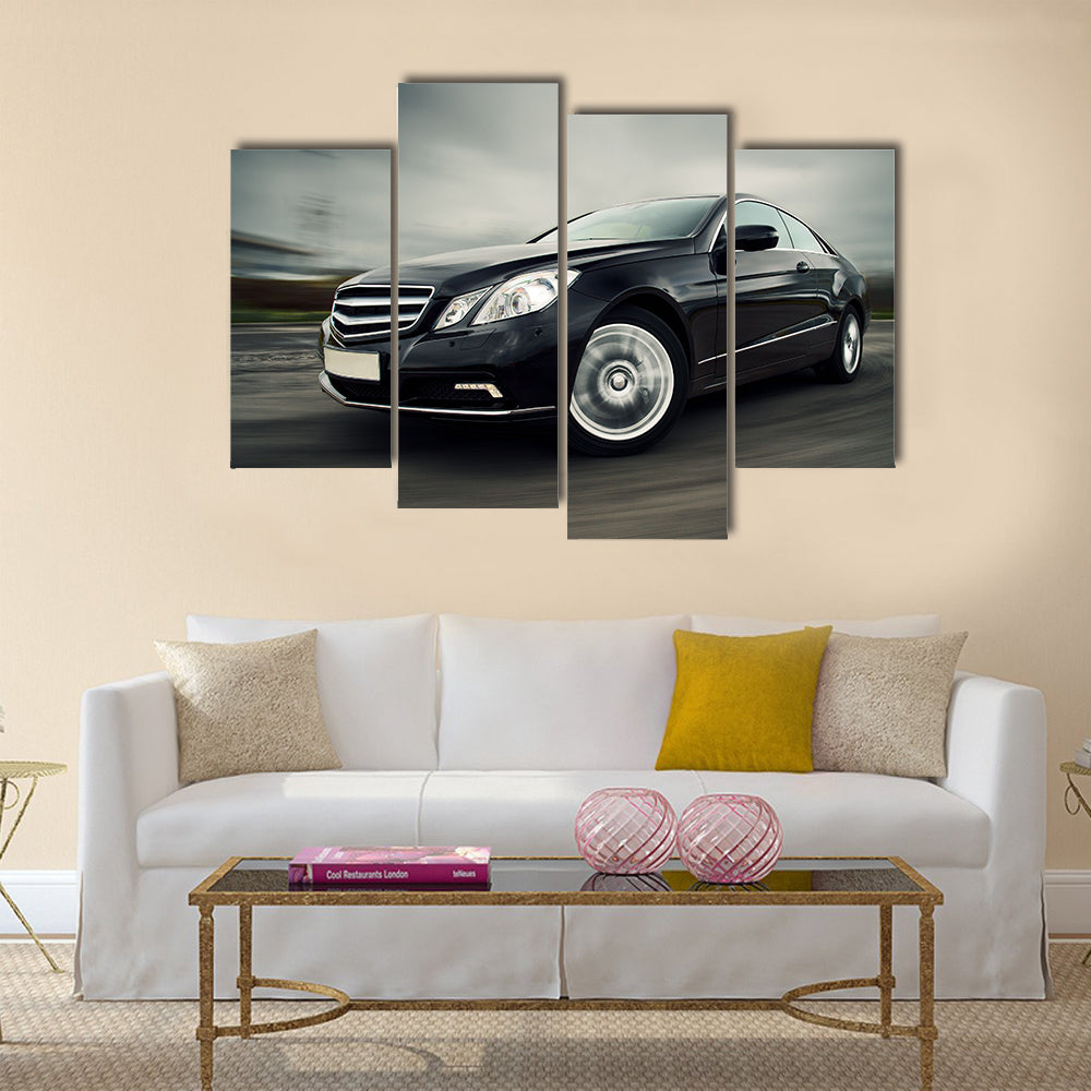 Front view of black luxury coupe driving fast Multi panel canvas wall art