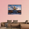 The sun rises behind a Buddha statue in Busan, South Korea multi panel canvas wall art