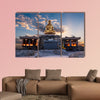 The sun rises behind a Buddha statue in Busan, South Korea multi panel canvas wall art