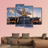 The sun rises behind a Buddha statue in Busan, South Korea multi panel canvas wall art