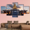 The sun rises behind a Buddha statue in Busan, South Korea multi panel canvas wall art