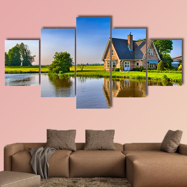 Red bricks house in countryside near the lake with mirror reflection in water wall art
