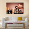 Male hand moving the black chess knight multi panel canvas wall art